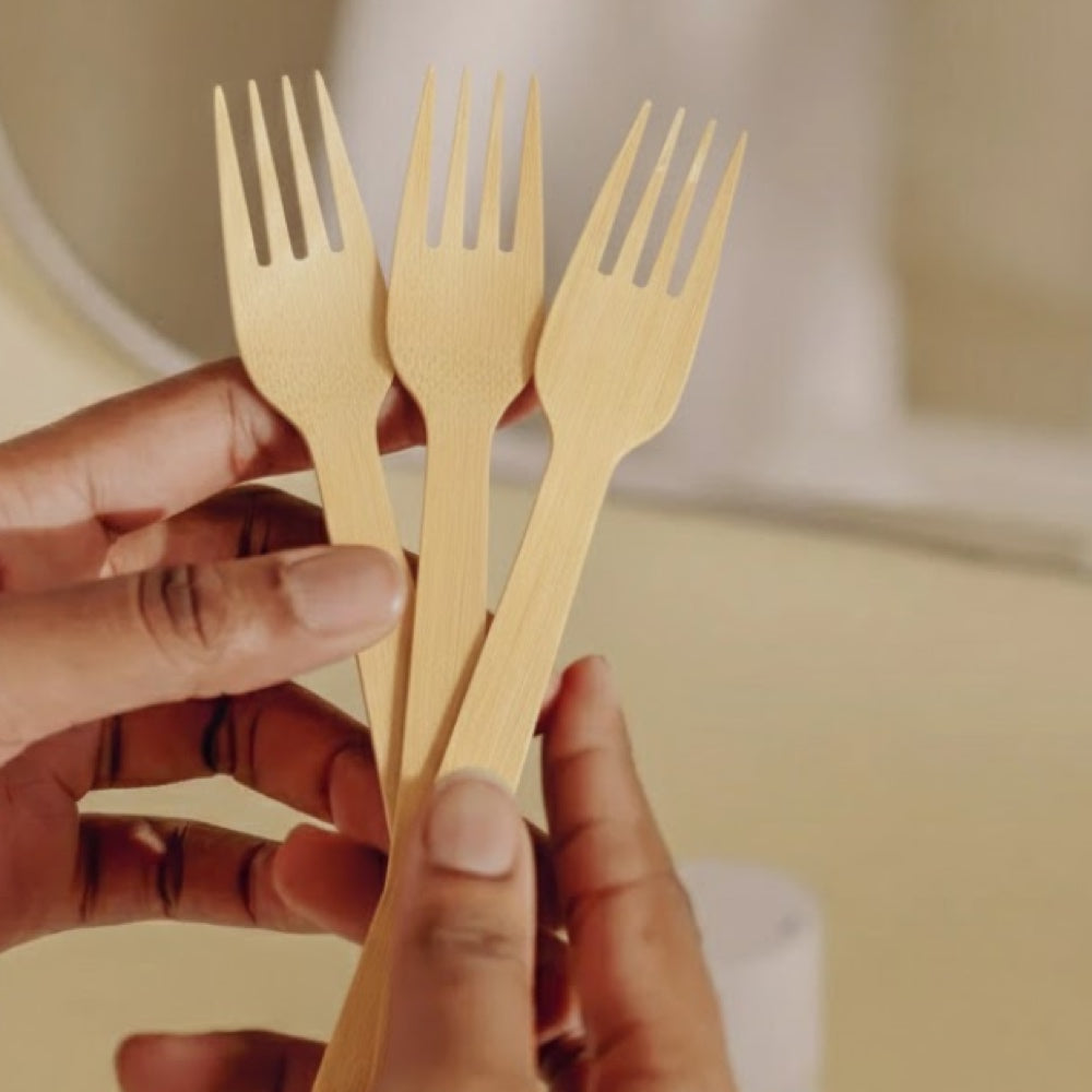 Hands holding three Bambi's bamboo forks